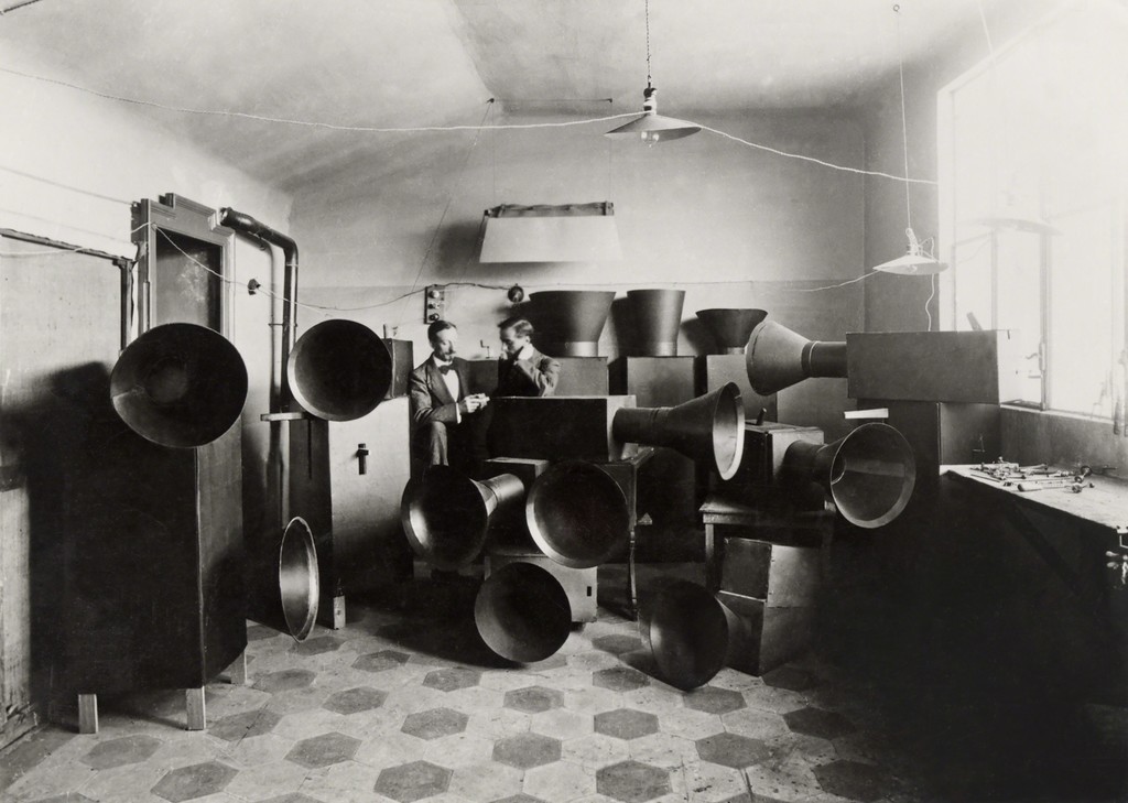 Luigi Russolo and his assistant Ugo Piatti in his studio with the intonarumori (noise machines), Milan